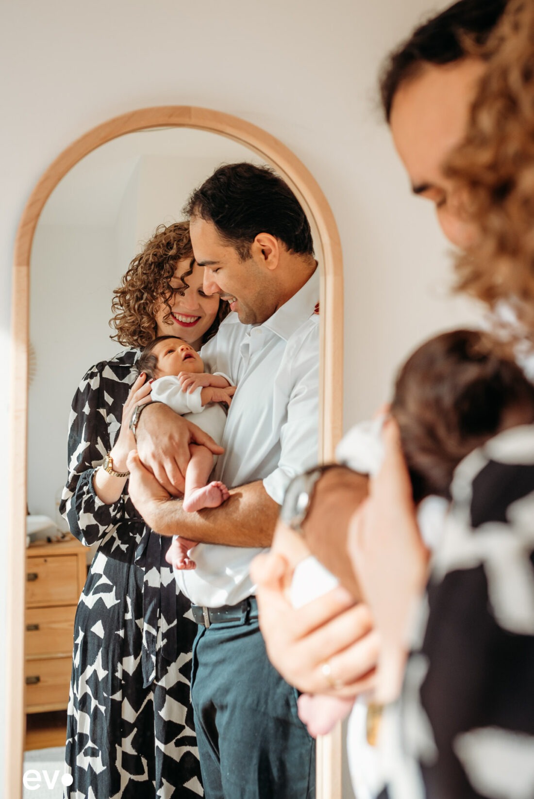 fresh parents looking at their newborn baby