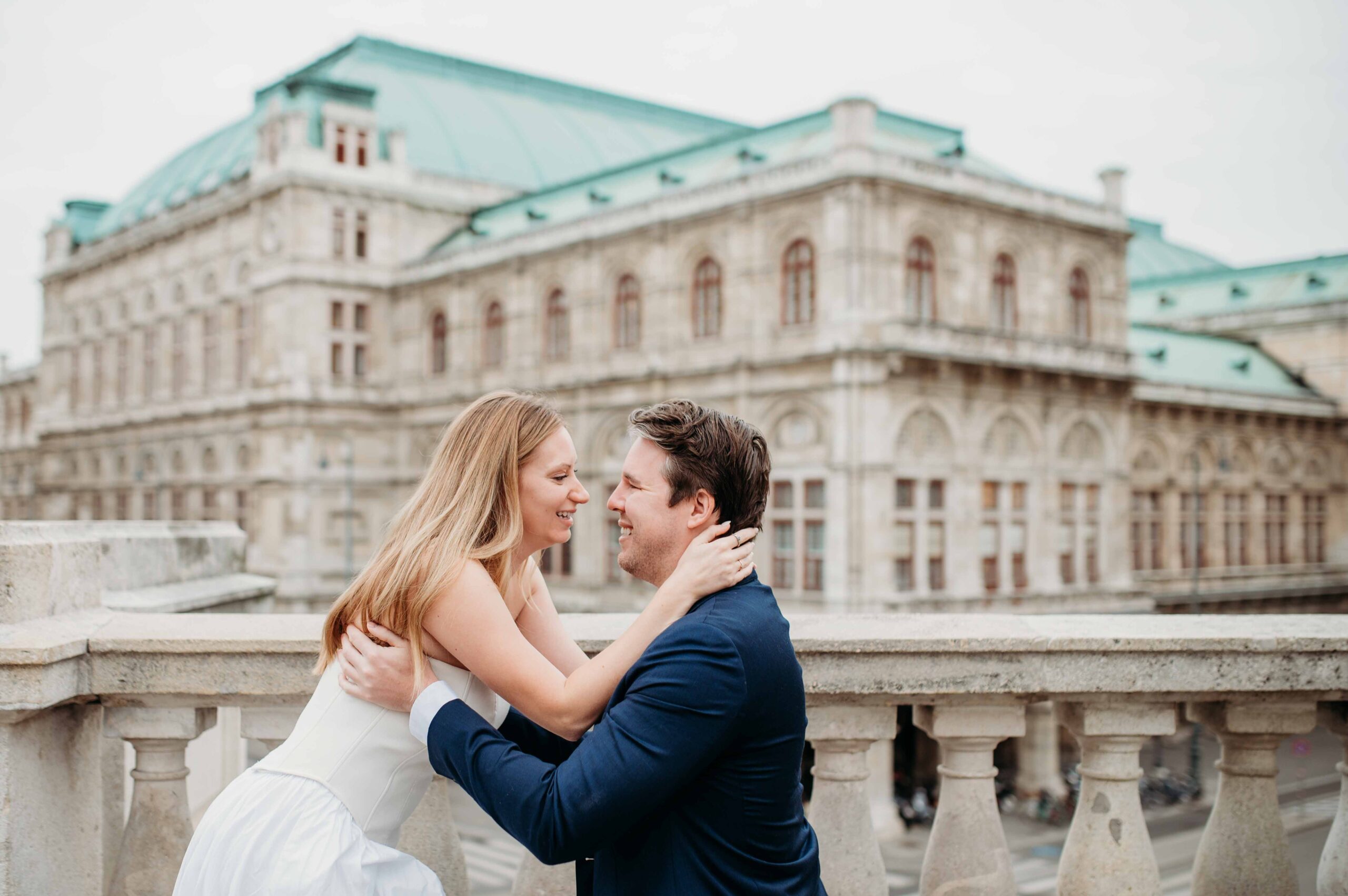 Couple laughing together during engagement photo shoot in Vienna city center
