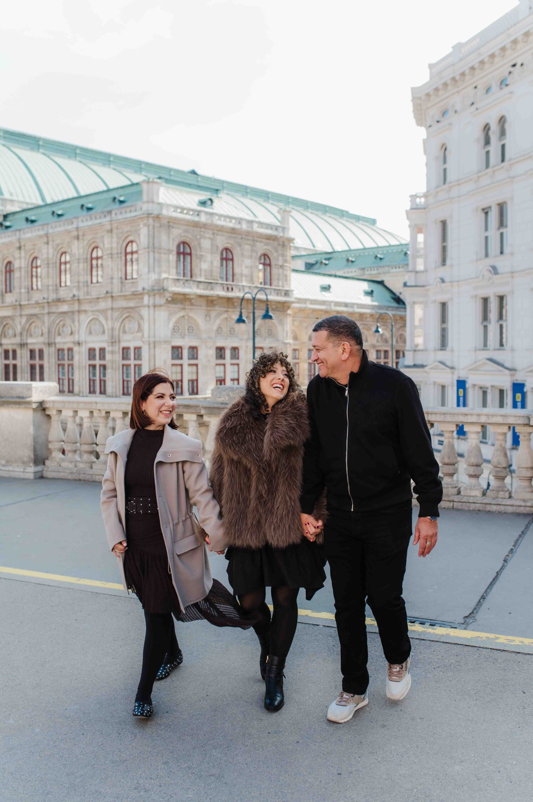 Family walking together near Vienna State Opera during city center photo shoot