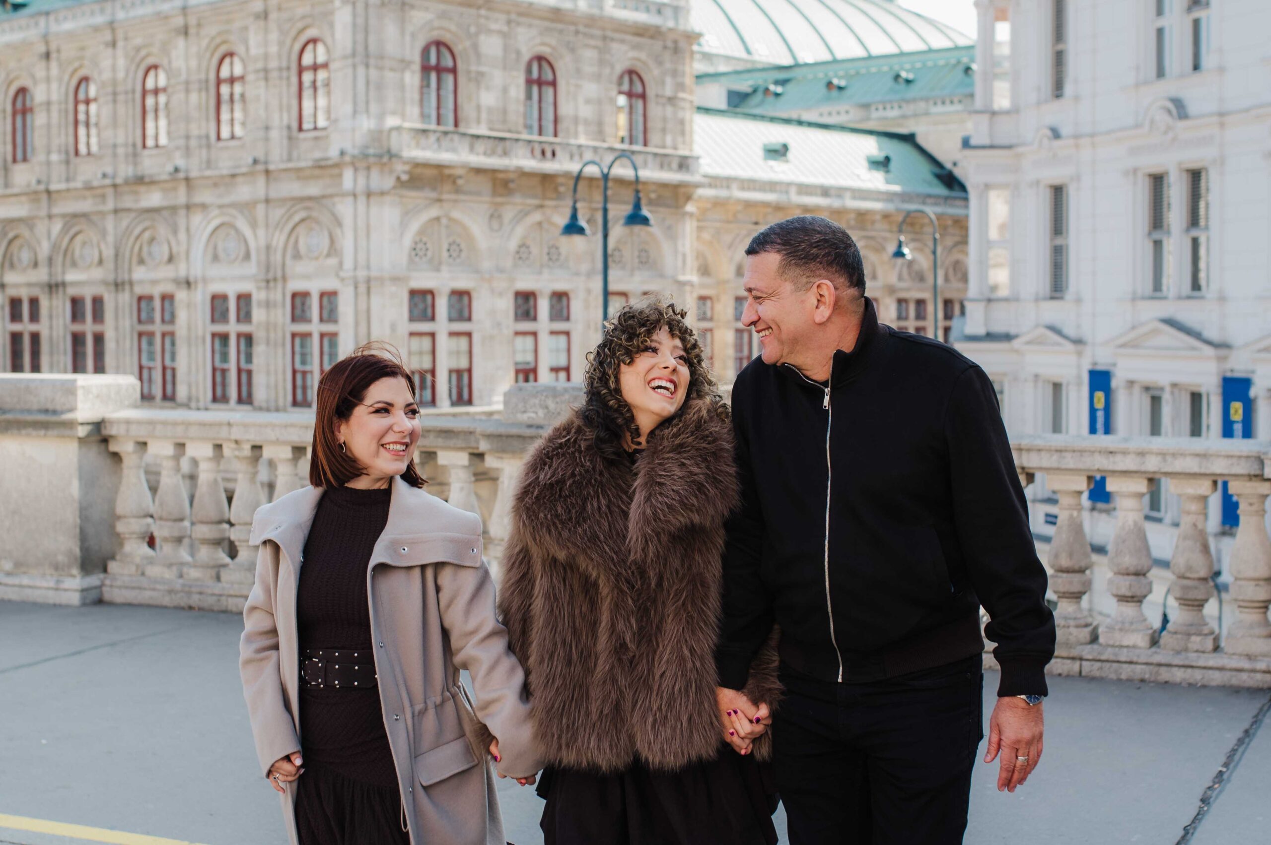 Family walking together near Vienna State Opera during city center photo shoot